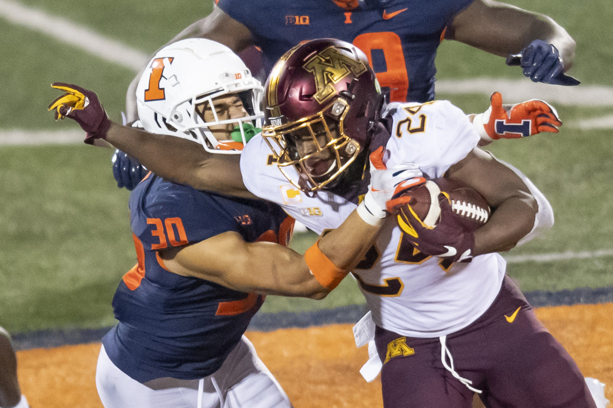 Minnesota Golden Gophers running back Mohamed Ibrahim (24) runs the ball against Illinois Fighting Illini defensive back Sydney Brown (30) during the second half at Memorial Stadium.
